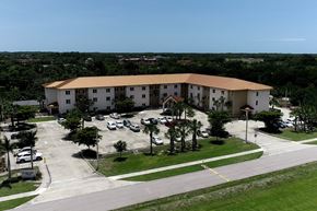 Fort Myers apartment for rent - St. John XXIII Villas with large parking lot and palm trees