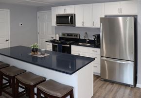 Scranton apartment for rent - a kitchen with stainless steel appliances and a black counter top