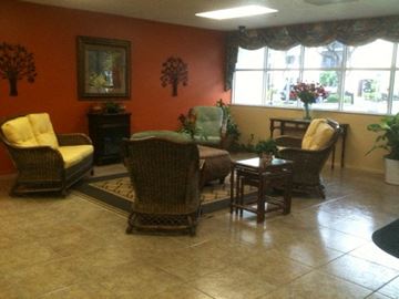 Sarasota apartment for rent - a living room with wicker chairs and a table