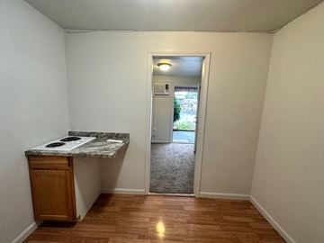 Pea Ridge apartment for rent - A kitchen area with a counter and a cabinet.