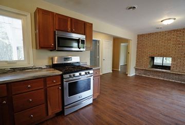 Eagan apartment for rent - A kitchen with a stove top oven and microwave.