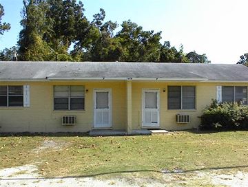 Beaufort - Coming Available 7/2/26 apartment for rent - A yellow house with a grey roof and white doors and windows.