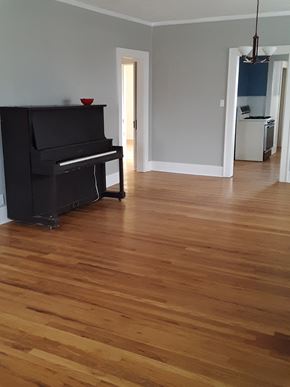 Cheyenne apartment for rent - A black piano sits in a room with wooden floors.