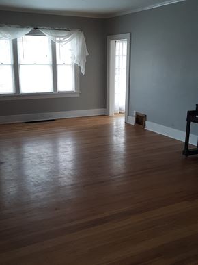 Cheyenne apartment for rent - A room with wooden floors and a window with curtains.