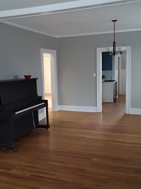 Cheyenne apartment for rent - A black piano sits in a room with wooden floors and white walls.