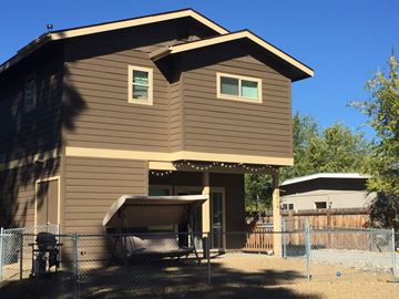 Flagstaff house for rent - a home with a fenced in yard and a fence
