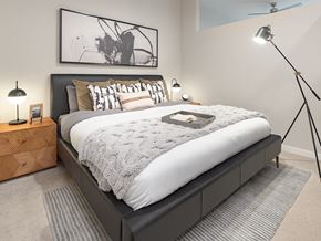 San Antonio apartment for rent - A bedroom with a large bed and a painting above it.