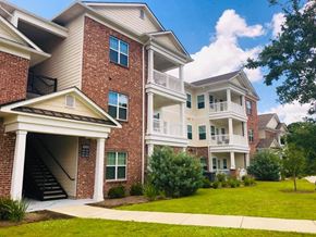 Brunswick apartment for rent - a brick apartment building with a lawn and a staircase