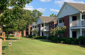 Moultrie apartment for rent - our apartments are located in the community with a green lawn and trees
