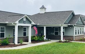 Winston-Salem apartment for rent - A building with a grey roof and a flag on the front.