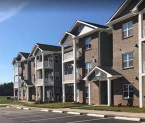 Winston-Salem apartment for rent - A row of modern apartment buildings with balconies and patios.