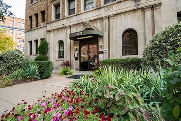 Washington apartment for rent - A building with a green awning and the number 3221 on it.