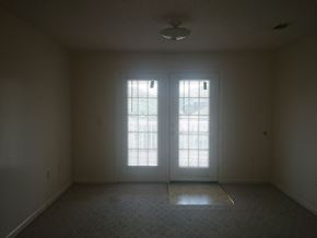 Vidalia apartment for rent - an empty living room with two doors and a window