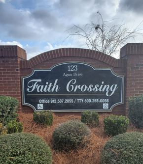 Vidalia apartment for rent - a sign for faith crossing on the side of a brick wall