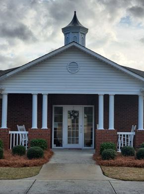 Vidalia apartment for rent - the front of a church with white pillars and a bell tower