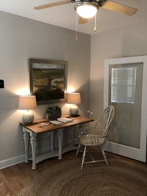 Rincon apartment for rent - a home office with a desk and chair and a painting on the wall