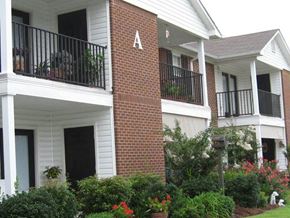 Tifton apartment for rent - a brick house with a porch and a balcony