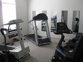 Tifton apartment for rent - a gym with various pieces of exercise equipment