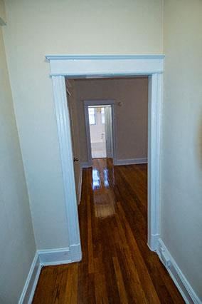 Washington apartment for rent - A hallway with a brown door at the end.