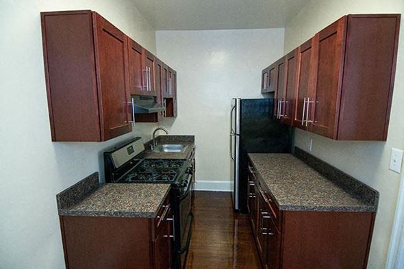 Washington apartment for rent - A kitchen with brown cabinets and granite countertops.