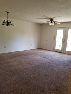 Fitzgerald apartment for rent - an empty living room with a ceiling fan
