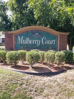 Fitzgerald apartment for rent - a sign for mulberry court in front of a building