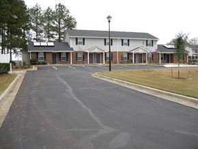 Wrightsville apartment for rent - A building with a parking lot in front of it.