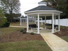 Wrightsville apartment for rent - A gazebo with a white fence and benches in front of a house.