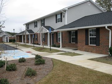 Wrightsville apartment for rent - A row of houses with a pool in the front yard.