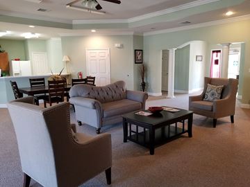 Jesup apartment for rent - a living room with couches and chairs and a table