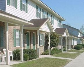 Bowman apartment for rent - a row of houses with green doors and white bricks