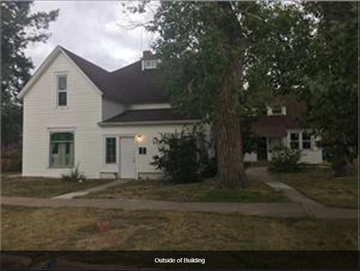 Cheyenne apartment for rent - a white house with a large tree in front of it