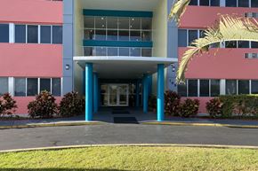Homestead apartment for rent - Deedco Gardens entrance with driveway, covered walkway, and landscaping