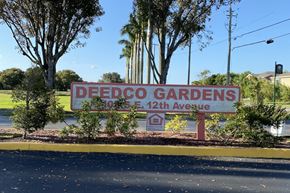 Homestead apartment for rent - Deedco Gardens Signage with lush trees and bushes