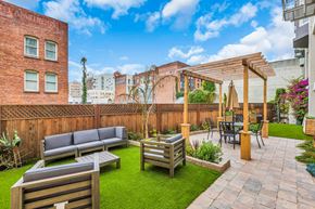 San Francisco apartment for rent - A backyard with a wooden fence and a patio area.