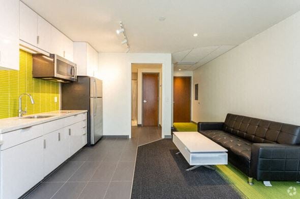 Ithaca apartment for rent - A modern kitchen with a black couch and a bench.