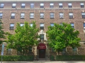 Ithaca apartment for rent - A building with a red awning and a sign that says "The corner".