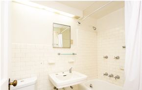 Ithaca apartment for rent - A white bathroom with a sink, mirror, and bathtub.