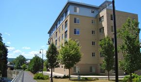 Ithaca apartment for rent - a tall building with trees in front of it
