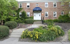 Ithaca apartment for rent - A brick building with a white door and a sign that says "Most Meeting".