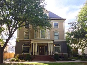 Ithaca apartment for rent - A large house with a front porch and a tree in front.