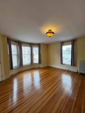 Ithaca apartment for rent - A room with wooden floors and a ceiling light.