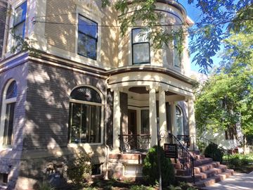 Ithaca apartment for rent - A Victorian style house with a front porch and stairs leading up to the entrance.