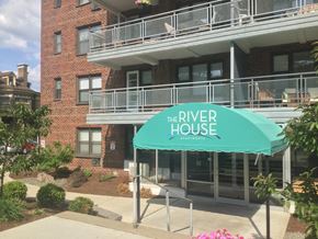 Binghamton apartment for rent - A building with a balcony and a green awning that says "The River House".