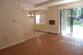 Millis apartment for rent - an empty living room with a wood floor and a sliding glass door