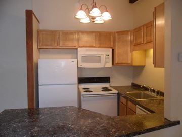 Stoughton apartment for rent - a kitchen with white appliances and granite counter tops