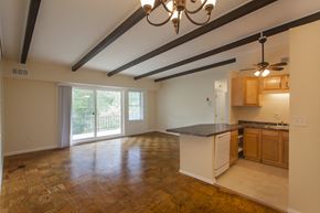 Stoughton apartment for rent - an empty living room with a kitchen and a sliding glass door