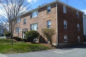Milford apartment for rent - a brick apartment building on the corner of a street