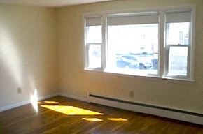 Milford apartment for rent - an empty room with a large window and wooden floors