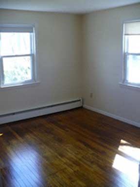 Milford apartment for rent - an empty room with a wooden floor and two windows